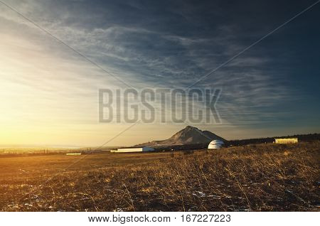Galicia in the form of a dome on a background of the Caucasus Mountains in the sunset light