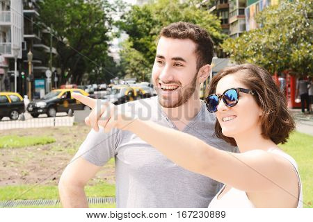 Portrait of a young beautiful tourist couple. Outdoors.
