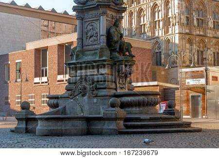 Cologne, Germany - January 19, 2017: Fragment of the fountain-monument of Jan von Werth. In the background the tower of City Hall and the entrance to the metro station.