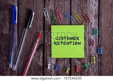 Tolls With Notes CUSTOMER RETENTION Conceptual On Wooden Background