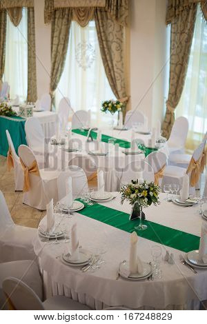 The table decorations for weddings with tall flower arrangement. Wedding concept