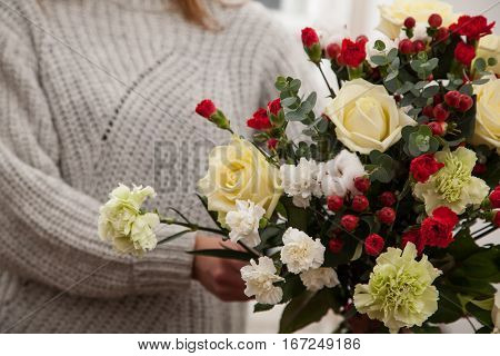 Closeup of woman florist holding beautiful fresh Bouquet of flowers