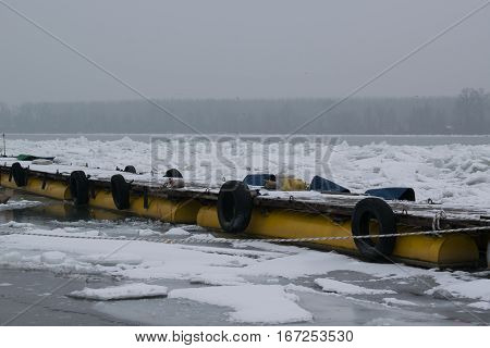 Frozen River With Accumulated Drift Ice Putting Preasure On Docks And Boats