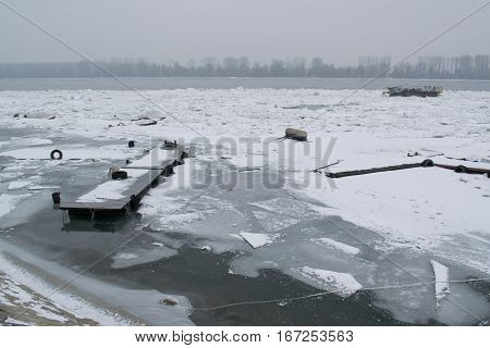 Frozen River With Accumulated Drift Ice Putting Preasure On Docks And Boats