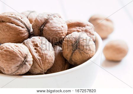 Whole walnuts close-up on a white table