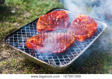 striped mutton steak on non-permanent foil grill closeup