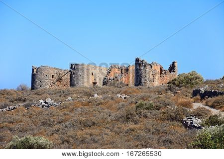 Windmill ruins on a hillside near Elounda Crete Greece Europe.