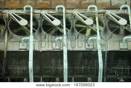 Large roof top fans and condensers that control the heating air conditioning and ventilation of a building below in Guangzhou China.