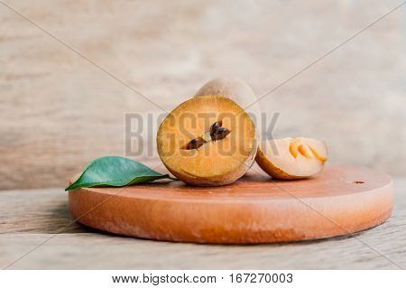 Fresh Sapodilla Fruits On Old Wooden Background
