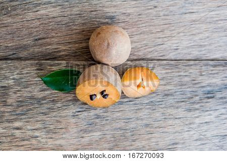 Fresh Sapodilla Fruits On Old Wooden Background