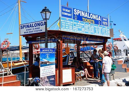 ELOUNDA, CRETE - SEPTEMBER 17, 2016 - Spinalonga trip booking office with boats to the rear Elounda Crete Greece Europe, September 17, 2016.