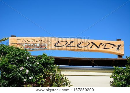 ELOUNDA, CRETE - SEPTEMBER 17, 2016 - Olondi taverna sign along the waterfront Elounda Crete Greece Europe, September 17, 2016.