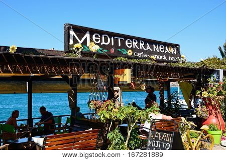 ELOUNDA, CRETE - SEPTEMBER 17, 2016 - Greek taverna along the waterfront with views across the bay Elounda Crete Greece Europe, September 17, 2016.