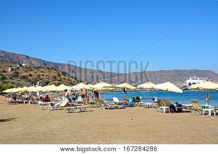 ELOUNDA, CRETE - SEPTEMBER 17, 2016 - Tourists relaxing on the beach Elounda Crete Greece Europe, September 17, 2016.