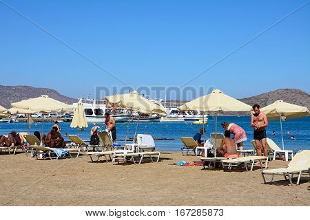 ELOUNDA, CRETE - SEPTEMBER 17, 2016 - Tourists relaxing on the beach Elounda Crete Greece Europe, September 17, 2016.