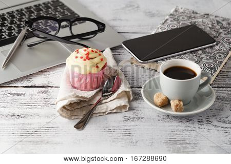 Coffee Cup And Muffin On Table With Computer