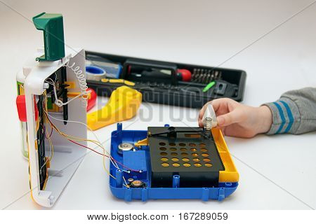 Boy trying to glue his cash register