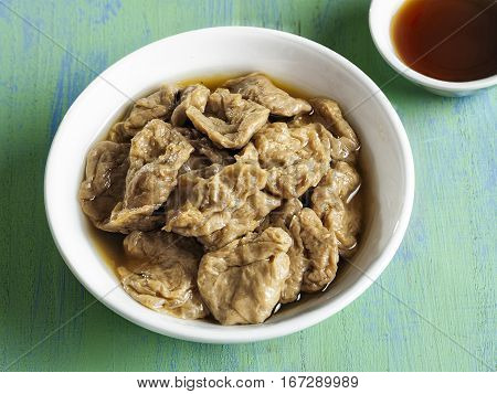 close up of a bowl of seitan vegetarian mock abalone