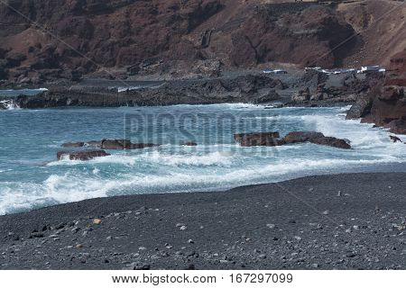 Wild sea and volcanic lava rocks at the Los Hervideros west coast of Lanzarote island Spain