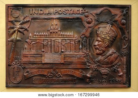 KOLKATA,INDIA - FEBRUARY 09, 2016: Celebrate silver jubilee of coronation of King George V(1935) issued stamp depicting Sri Sital Nath Jain Temple, Street bass relief on the wall of Jain Temple