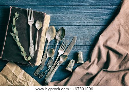 Set of silverware on wooden background