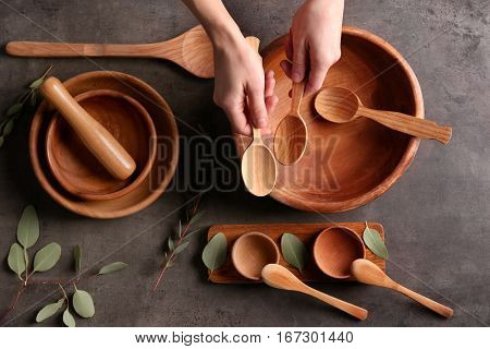 Female hands and dishware on grey background