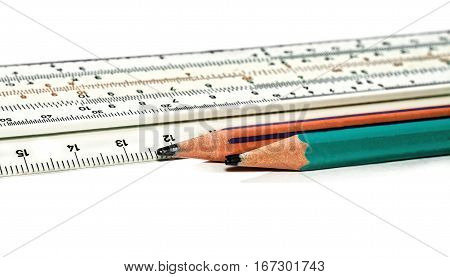 Pencils and slide rule isolated on white background