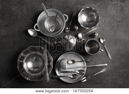 Set of dishes and cutlery on gray background
