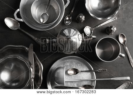 Set of dishes and cutlery on gray background