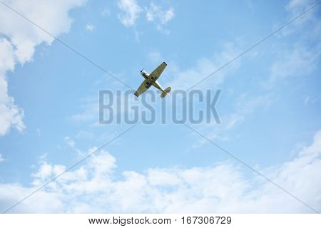 Airplane flies in the cloudy sky. Natural light and colors