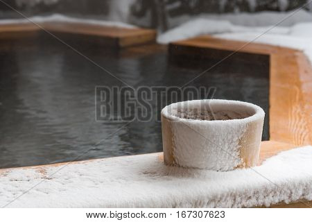 Japan natural mineral hot spring called onsen cover by snow in Japanese ryokan on the moutain okuhida takayama japan.