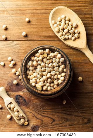 Portion of Chick Peas in wooden bowl with spoon top view