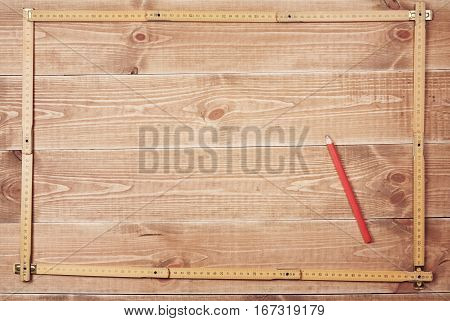 carpenter's ruler and pencil on a wooden planks