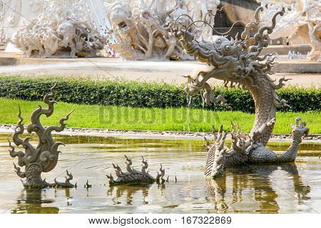 Thai Myth Dragon Sculpture Splashing Water in Wat Rong Khun Thailand