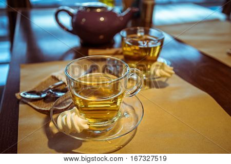 Hot tea cup on a frosty winter day window background sunset