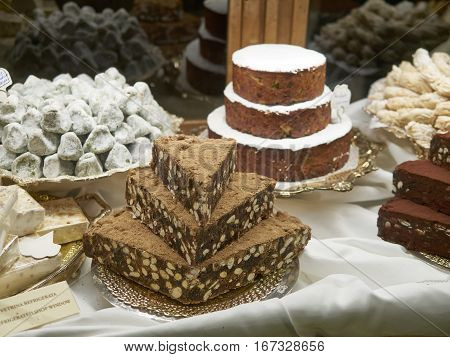 Panforte nero squares . Traditional italian cake with nuts and dried fruits in a pastry