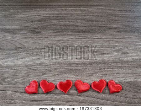 Valentines Day background. Red hearts on the wooden table. Top view with copy space
