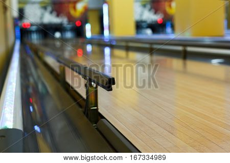 Bowling alley background. Lane with bumper rails closeup. Leisure activity club