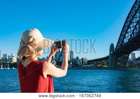 Woman In Red Top And Summer Hat Taking Pictures Of Sydney Harbour