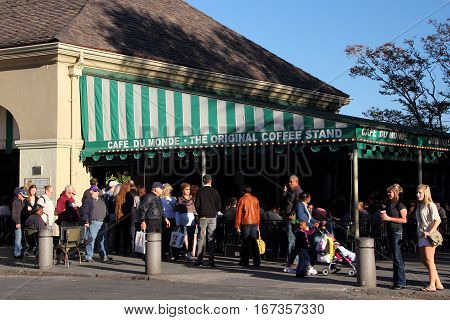 NEW ORLEANS, LA - NOVEMBER 24: Tourists enjoy a bit of New Orleans cuisine at the famous Cafe Du Monde in front of Jackson Square in the historic French Quarter November 24, 2012 in New Orleans, LA.