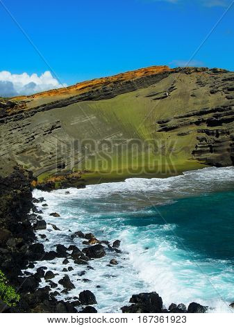 Green sand is formed naturally from volcanic rock on Hawaii's big island creating a green beach.