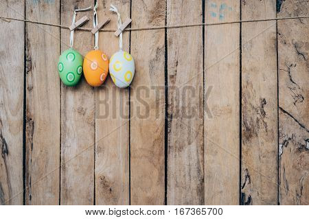 Easter Egg Hanging Clothseline On Wood Backhround With Space.
