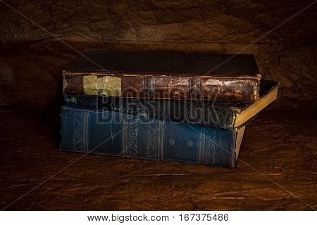 Old ancient book in worn dark hardcover.