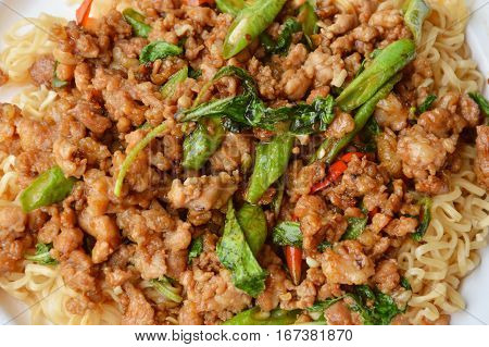 instant noodle topping spicy stir fried minced pork and basil leaf on dish