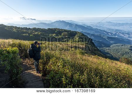Man with camera shoot view at kew mae parn viewpoint. Doi Inthanon Chiang Mai in Thailand