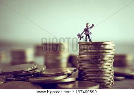 Miniature Child Standing On Top Of The Money Save Money Concept.
