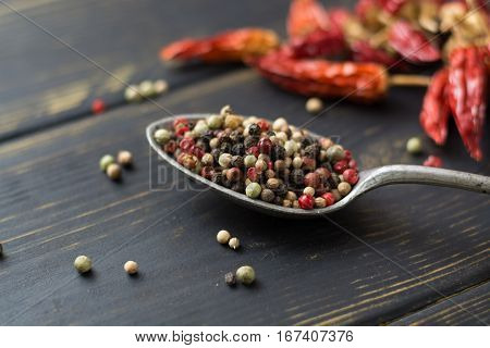 Red hot chili cayenne peppers dried variety - spicy ingredient in old tin spoon