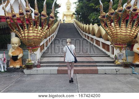 Big Gold Buddha sits and silently watches vanity below