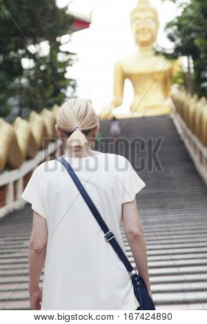 Big Gold Buddha sits and silently watches vanity below