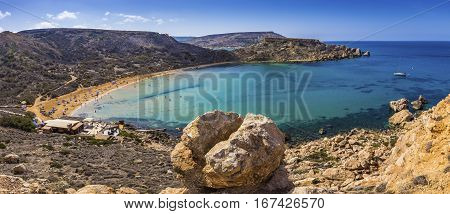 Ghajn Tuffieha Malta - Beautiful summer day at Ghajn Tuffieha sandy beach with blue sky and crystal clear green sea water